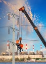 Electrician worker working on high voltage electric pole with cr