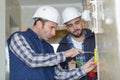 electrician workers on electric power switch in fuse board