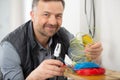 electrician working with cables and assembling new wiring Royalty Free Stock Photo