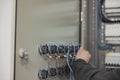 electrician working on electric panel, closeup of hands Royalty Free Stock Photo