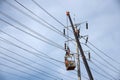 Electrician working on electric pole