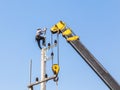 Electrician working in the height with crane.