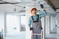 Electrician installing ventilation system on construction site Royalty Free Stock Photo