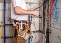 Electrician working near the Board with wires. Installation and connection of electrics