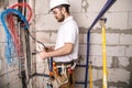 Electrician working near the Board with wires. Installation and connection of electrics