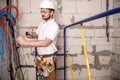 Electrician working near the Board with wires. Installation and connection of electrics