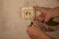 Electrician working at plug socket in a kitchen,horizontal Royalty Free Stock Photo