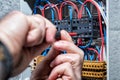 Electrician working on a residential electrical panel. Electricity