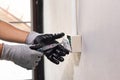 Electrician working safely on sockets of a residential electrical system