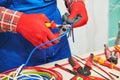 Electrician works with cable. hands with Cable Shears Royalty Free Stock Photo