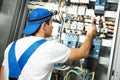 Electrician works with electric meter tester in fuse box Royalty Free Stock Photo