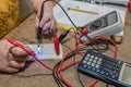 Electrician works with voltage tester - close-up