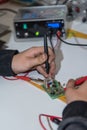 Electrician works with voltage tester