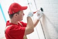 Electrician works with wall outlet. installing or repair switch Royalty Free Stock Photo