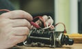 Electricians hands repairs old electric switch