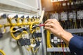 Electricians hands testing current  electric in control panel Royalty Free Stock Photo