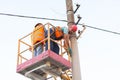 Electricians on the pillars install the mount for the power line. Professional electricians work on the tower Royalty Free Stock Photo