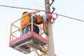 Electricians on the pillars install the mount for the power line. Professional electricians work on the tower Royalty Free Stock Photo