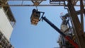 Electricians repair the power line with a lift.