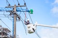 Electricians repairing wire of the power line with bucket hydraulic lifting platform