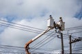 electricians repairing wire of the power line on electric power pole Royalty Free Stock Photo