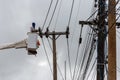 electricians repairing wire of the power line on electric power pole Royalty Free Stock Photo