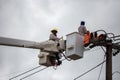 electricians repairing wire of the power line on electric power Royalty Free Stock Photo
