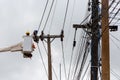 electricians repairing wire of the power line on electric power pole Royalty Free Stock Photo