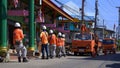 Electricians team with crane trucks working on the street