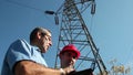 Electricians Under the High Voltage Tower