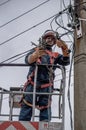 Electricians work on inspection and replacement of lighting poles.