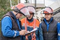 Electricians work on inspection and replacement of lighting poles.