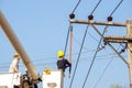 Electricians working on cable car to repair the power line