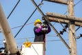 Electricians working on cable car to repair the power line