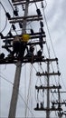 Electricians working on the electric post power pole. Royalty Free Stock Photo