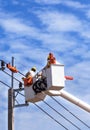 Electricians working in the height on basket hydraulic platform