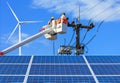 Electricians working repairing wire of the power line with solar panels and wind turbines Royalty Free Stock Photo