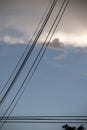 electricity cable over a blue sky with clouds Royalty Free Stock Photo