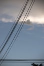 electricity cable over a blue sky with clouds