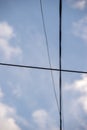 electricity cable over a blue sky with clouds