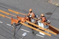 Electricity company employees perform maintenance on distribution line