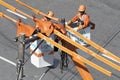 Electricity company employees perform maintenance on distribution line