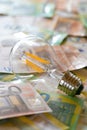 Electricity cost. light bulb on euro bills.Rising electricity prices in Europe.energy Crisis production in the EU Royalty Free Stock Photo