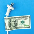 Electricity costs. Electrical power cable and money, dollar bills. Energy savings, energy efficiency concept Royalty Free Stock Photo