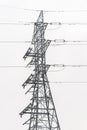 Electricity distribution system. High voltage overhead power line, power pylon, steel lattice tower standing in the field. Blue Royalty Free Stock Photo