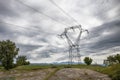 Electricity distribution tower, power line against cloudy sky