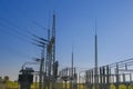 Electricity and energy.Power station in the rays of the sun on a blue sky background.Energy equipment.High tension power Royalty Free Stock Photo