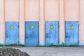 Electricity, high voltage. danger high voltage. row of old metal doors in special building wall. vintage industrial outdoor