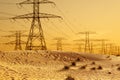 Electricity or  high voltage power lines in dessert at sunset Royalty Free Stock Photo