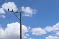 Electricity high voltage system, electric pole, transmission line, insulator supporting isolated on blue sky and white cloud Royalty Free Stock Photo